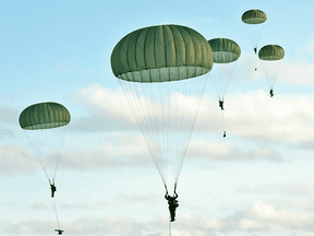 Soldiers from 3rd Battalion, the Royal Canadian Regiment Mike Company parachute from a C130J Hercules aircraft at Garrison Petawawa, Ont., in November 2014.