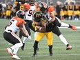Receiver Branlon Addison of the Hamilton Tiger-Cats is tackled by B.C. Lions' linebacker Maleki Harris during Saturday's CFL action at Tim Hortons Field in Hamilton, Ont.