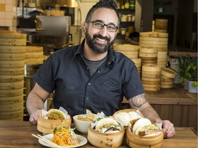Gongfu Bao chef/owner Tarek Hassan with a variety of items from his menu.