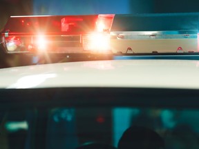 Police light and siren on the car in action. Siren on police car flashing, close-up. Emergency flashing police siren. Police signal flasher isolated. Red siren flasher on the police car at night.