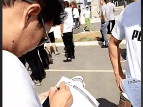 This screen grab of a video taken at a pro-China rally near Toronto appears to show attendees filling in Liberal membership forms.