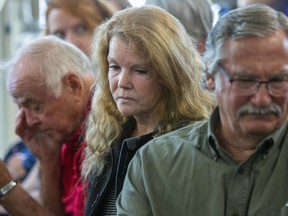 Left to Right: Stan Millard, Muriel Burnley and her husband Dan Silcox listen to Commissioner Eileen Gillese speak at the release of the final report of a two-year probe into the long-term care system sparked by the murders of eight people by former nurse Elizabeth Wettlaufer. Millard is the son of Gladys Millard and Dan Silcox is the son of James Silcox, two of Wettlaufer's victims.