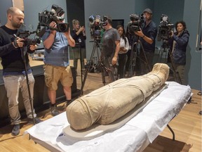 Media make images of the Egyptian mummy Nestawedjat, which dates to approximately 700 BC, at a press preview at the Museum of Fine Arts Wednesday, August 28, 2019 in Montreal. The museum will be showing the exhibition Egyptian Mummies: Exploring Ancient Lives this fall and winter.