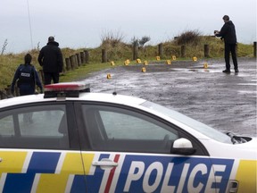 Police collect and photograph evidence in the carpark of the Te Toto Gorge lookout on Whaanga Rd, south of Raglan, New Zealand, Friday, Aug. 16, 2019.