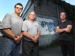 Malcolm Griffin and  Louis Griffin of Griffin Automotive Services enlisted artist Christopher Griffin, right, to turn a graffiti tag into art. The a city bylaw officer stepped in.