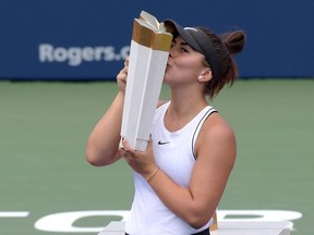 Bianca Andreescu kisses the winners trophy after defeating Serena Williams (USA) during the womens final of the Rogers Cup tennis tournament at Aviva Centre.