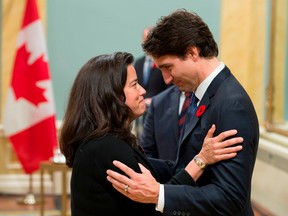 In this file photo taken on November 04, 2015, Canadian Prime Minister Justin Trudeau speaks with Minister of Justice Jody Wilson-Raybould during a swearing-in ceremony at Rideau Hall, Wednesday Nov.4, 2015 in Ottawa.