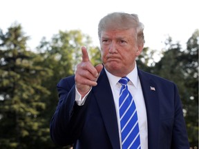 U.S. President Donald Trump speaks with reporters.