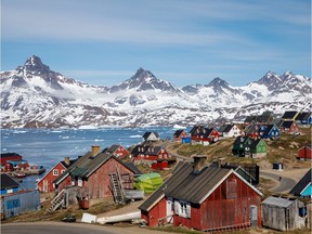 FILE PHOTO: Snow covered mountains rise above the harbour and town of Tasiilaq, Greenland, June 15, 2018.