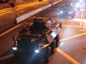 Military vehicles of the Chinese People's Liberation Army (PLA) pass Huanggang Port for a routine troop rotation in Hong Kong, August 29, 2019.