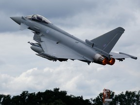 A Eurofighter Typhoon fighter jet performs a flying display on the second day of the Farnborough International Airshow 2016 in Farnborough, U.K., on Tuesday, July 12, 2016.