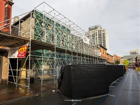 A historic building at 35 William Street in the Byward Market area of Ottawa sits shrouded in scaffolding. The building was heavily damaged by fire in April of 2019.