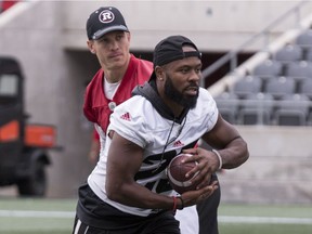 Ottawa Redblacks quarterback Trevor Harris hands off the ball to running back William Powell during team practice at TD Stadium, Sept. 18, 2018.