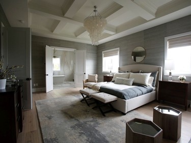 There's a sense of entry into the master suite, with steps leading up to double doors that are flanked by bookshelves. Once inside, there's a cosiness to the large room, thanks to lots of layering -- in the grass cloth wrapping the walls, the coffered ceiling, the soft textures and the muted tones.