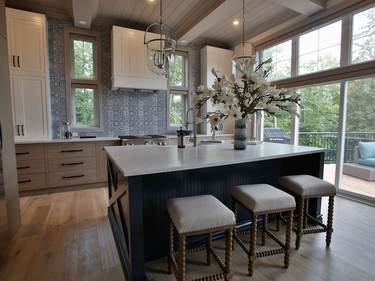 The kitchen layout was altered in order to open up the whole back wall. 'Light is flooded through,' says designer Tanya Collins. Cabinets by Laurysen Kitchens are a mix of white Shaker and wood