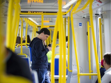 Day two of the light-rail transit had commuters and the general public out checking out the LRT system Sunday September 15, 2019. A man checks his phone on the train Sunday morning.
