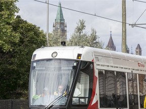 The train is seen exiting the tunnel at uOttawa with Parliament Hill looming in the background as the LRT is in operation on day 2 of the system up and running. Photo by Wayne Cuddington/ Postmedia