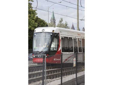 The train is seen exiting the tunnel at uOttawa with Parliament Hill looming in the background as the LRT is in operation on day 2 of the system up and running.