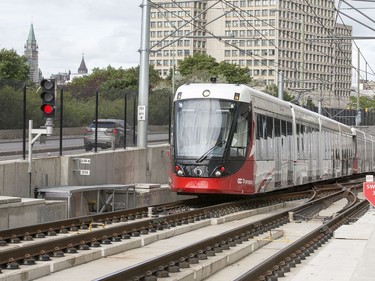 The train is seen exiting the tunnel at uOttawa with Parliament Hill looming in the background as the LRT is in operation on day 2 of the system up and running.