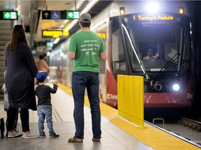 Caleb Jennings, 3, waves to the engineer as the train arrives at Parliament Station on the weekend.