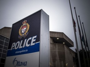 The flags were flying at half mast in front of the Ottawa Police Service Elgin Street location following the death of Det. Thomas Roberts, Saturday Sept. 28, 2019.   Ashley Fraser/Postmedia