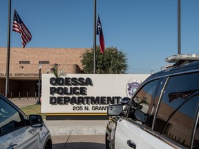 ODESSA, TX - SEPTEMBER 1: Flowers hang on the Odessa Police Department sign following a deadly shooting spree on September 1, 2019 in Odessa, Texas. Seven people had been killed, in addition to the gunman and at least 21 others were wounded, including three law enforcement officers after a gunman went on a rampage.