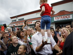Justin Trudeau balances a baby during a campaign stop in Niagara Falls earlier this week.