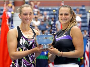 Elise Mertens (left) of Belgium and Aryna Sabalenka of Belarus pose with the trophy after winning their Women's Double's final match against Victoria Azarenka of Belarus and Ashleigh Barty of Australia on day fourteen of the 2019 US Open at the USTA Billie Jean King National Tennis Center on Sunday in New York City.