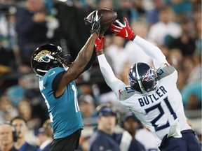Dede Westbrook #12 of the Jacksonville Jaguars makes a catch against Malcolm Butler #21 of the Tennessee Titans during the first quarter of a game at TIAA Bank Field on September 19, 2019 in Jacksonville, Florida.
