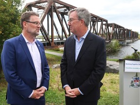 Mayor Jim Watson (right) and Gatineau Mayor Maxime Pedneaud-Jobin aren't fans of using the Prince of Wales bridge, behind them, for mass transit.