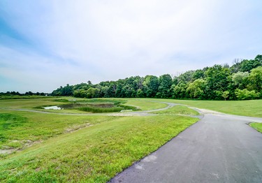 The pond and green space at Place St. Thomas in Embrun by Valecraft Homes.