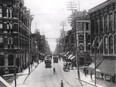 A historic photo shows streetcars traveling on a busy Sparks Street in 1903.