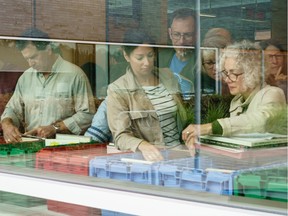 People sorting through thousands of records during a sell off of a record collection by the Friends of the Ottawa Public Library, at the James Bartleman Archives Saturday.