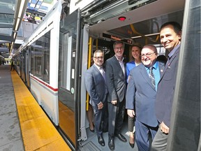 Steve Kannelakos, (from left), Mayor Jim Watson, Caroline Mulroney, Allan Hubley and John Manconi are all aboard the train for the first inaugural run as the LRT officially opens with ceremonies at Tunney's Pasture.