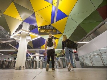 Passengers walk under a colourful ceiling as they head for a train at the Parliament Station as the LRT officially opens on September 14, 2019 complete with ceremonies at Tunney's Pasture.