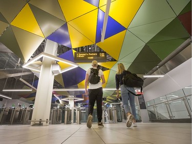 Passengers walk under a colourful ceiling as they head for a train at the Parliament Station as the LRT officially opens on September 14, 2019 complete with ceremonies at Tunney's Pasture.