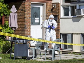 An investigator takes photos at 28A Forester Crescent in the Bells Corners area of Ottawa on September 25, 2019. A suspicious death occurred at the residence.