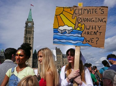 Friends (from left) Brittany Balcaran, Matilde Medini, and Charlotte Bridge on Parliament Hill as the Global Climate Protest took to the streets of Ottawa on Friday afternoon.