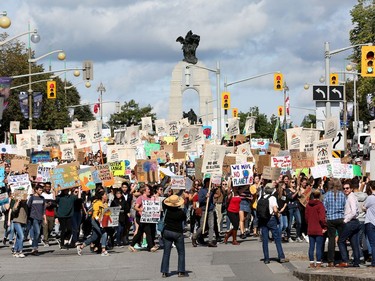 A large groups heads down Elgin Street towards Confederation Park as the Global Climate Protest took to the streets of Ottawa on Friday afternoon.