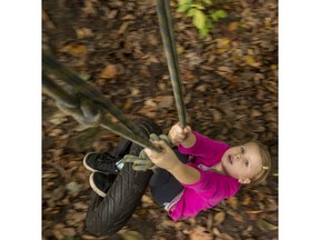 Jasmine MacDonald, 7, plays on the tire swing at the pop-up adventure playground on Friday.