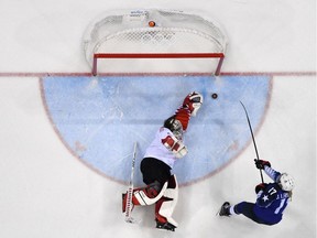 TOPSHOT - USA's Jocelyne Lamoureux-Davidson (R) scores past Canada's Shannon Szabados during the penalty-shot shootout in the women's gold medal ice hockey match between the US and Canada during the Pyeongchang 2018 Winter Olympic Games at the Gangneung Hockey Centre in Gangneung on February 22, 2018.