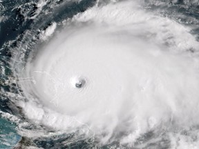 TOPSHOT - This satellite image obtained from NOAA/RAMMB, shows Tropical Storm Dorian as it approaches the Bahamas at 13:40 UTC on September 1, 2019. - Monster storm Dorian unleashed "catastrophic conditions" as it hit the northwestern Bahamas Sunday, becoming the strongest hurricane ever recorded in the region, US forecasters said. "Catastrophic hurricane conditions are occurring in the Abacos Islands and will spread across Grand Bahama Island later today and tonight," the National Hurricane Center wrote in its latest bulletin at 1500 GMT.Packing maximum sustained winds of 180 miles per hour (285 kph), the NHC said Dorian was now "the strongest hurricane in modern records for the northwestern Bahamas."