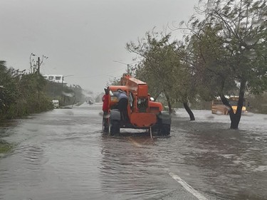 A heavy crane drives down a flooded road in Freeport in the Grand Bahamas on Tusday, as hurricane Dorian passes. Hurricane Dorian weakened slightly as it crawled towards the southeast coast of the United States on Tuesday after leaving at least five people dead and a swathe of destruction in the Bahamas.