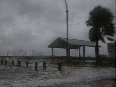 Strong gusts of wind and bands of heavy rain cover a pier at the Jensen Beach Causeway Park in Jensen Beach, Florida on Tuesday.