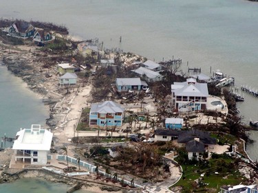 TOPSHOT - In this aerial image courtesy of a US Coast Guard Elizabeth City C-130 aircraft crew, homes and piers in the Bahamas lie damaged on September 3, 2019, after Hurricane Dorian. - Dorian churned towards the United States Wednesday after leaving seven dead in the Bahamas, where the prime minister said terrified residents had endured "days of horror" at the hands of the monster storm. Announcing the updated death toll, Prime Minister Hubert Minnis warned the number would rise as he called Dorian "one of the greatest national crises in our country's history."