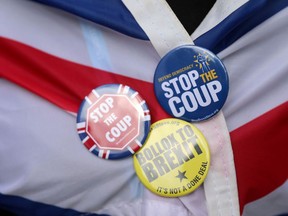 Anti-Brexit activist demonstrate near the Houses of Parliament in central London on September 26, 2019. - British Prime Minister Boris Johnson on Thursday lost yet another vote in parliament over a government request for a three-day recess to allow his Conservative party to hold its annual conference. The government lost the vote, which could affect the timing of the conference in Manchester, by 306 votes to 289.