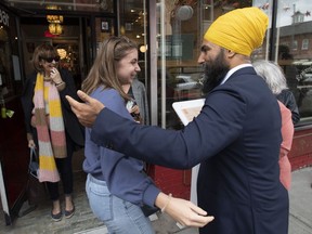NDP Leader Jagmeet Singh speaks with ladies as they leave a shop in Saint-Hyacinthe, Que. Sunday, September, 15, 2019. As the federal election campaign began last week, Canada's main political parties couldn't escape Quebec's internal politics and a renewed nationalism championed by the provincial government.THE CANADIAN PRESS/Adrian Wyld
