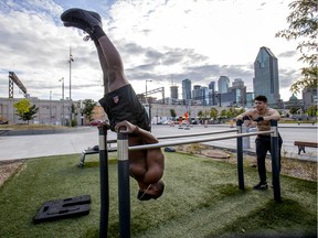 Carl-Olivier Prime, left, and So Kanon do a calisthenics workout at the outdoor gym on Robert-Bourassa Blvd. at William St. in Montreal on Friday August 30, 2019.