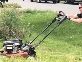 Ottawa police Const. Lisa Beaucage mowing the lawn