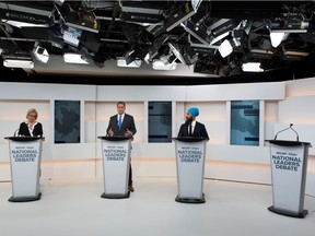 Green Party leader Elizabeth May, Conservative leader Andrew Scheer and New Democratic Party (NDP) leader Jagmeet Singh take part in the Maclean's/Citytv National Leaders Debate alongside an empty place due to the non appearance of Prime Minister Justin Trudeau, on the second day of the election campaign in Toronto.